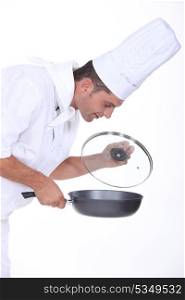 chef holding a frying pan