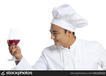 Chef holding glass with wine