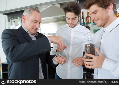 chef holding jar glass with coffee beans inside