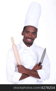 Chef holding knife and rolling pin