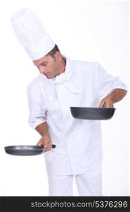 Chef holding two saucepans