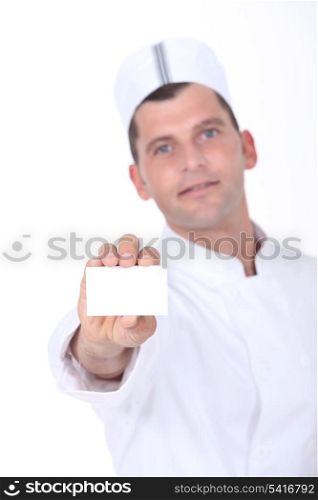 Chef holding up a blank business card