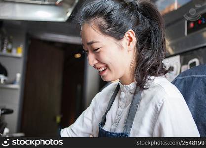 Chef in commercial kitchen smiling