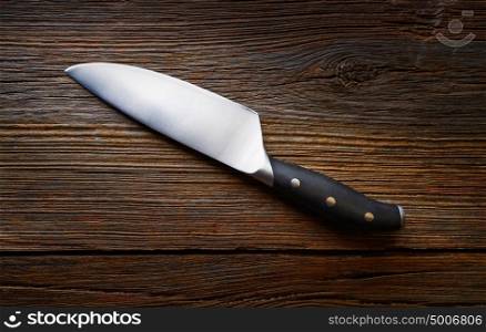 Chef knife on a wooden background texture