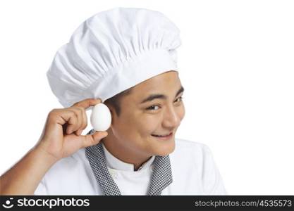 Chef listening to an egg