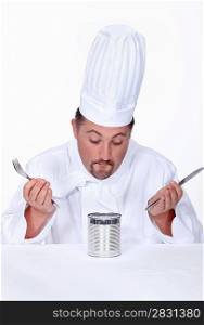 Chef looking at a tin of food