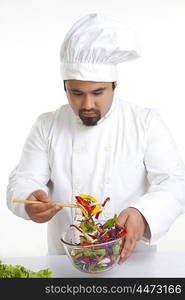 Chef looking at vegetables in bowl