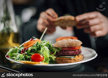 Chef making healthy vegetarian burgers, close up.. Chef Making Vegan Burgers in a Restaurant Kitchen 