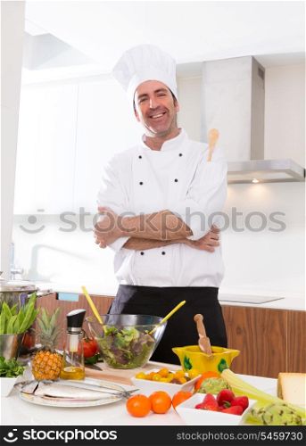Chef male portrait on white countertop with food at kitchen