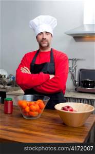 Chef man portrait with mustache in black and red on the kitchen