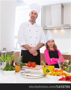 Chef master and junior pupil kid girl at cooking school with food on countertop