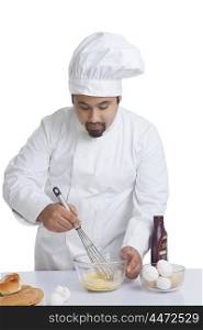 Chef mixing egg in bowl