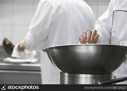 Chef mixing ingredients in bowl, close-up