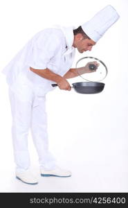 Chef monitoring sauce in pan