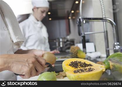 Chef peeling tropical fruit