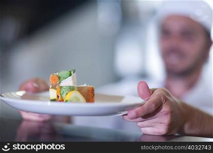 Chef placing meal on counter for service