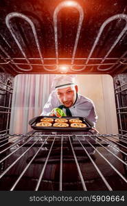 Chef prepares pastries in the oven, view from the inside of the oven. Cooking in the oven.