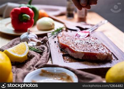 Chef prepares pork chop steak with barbecue sauce in the kitchen