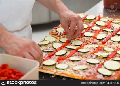 Chef preparing a delicious pizza with vegetables
