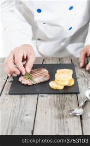 Chef preparing a piece of grilled beef