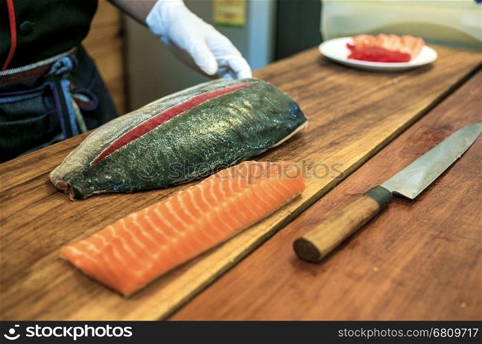 Chef preparing fresh tuna and salmon fillet