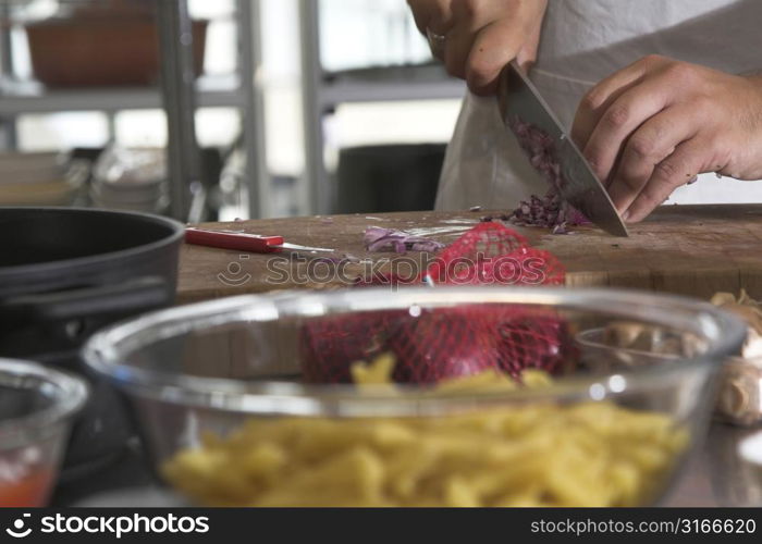 Chef preparing the onions for the pasta sauce