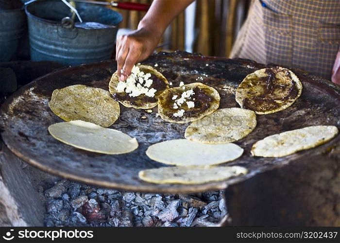 Chef preparing tortilla in a kitchen, Santo Tomas Jalieza, Oaxaca State, Mexico