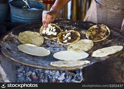 Chef preparing tortilla in a kitchen, Santo Tomas Jalieza, Oaxaca State, Mexico
