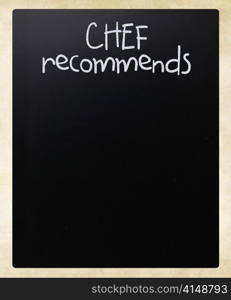 ""Chef recommends" handwritten with white chalk on a blackboard"