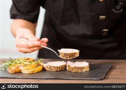 Chef riding a pork tenderloin dish with potatoes