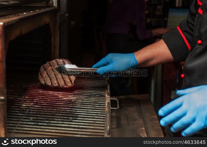Chef roasts meat steak. Chef roasts meat steak in the stove