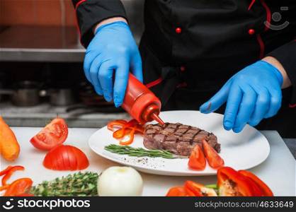 Chef set grilled meat. Chef set grilled meat steak on the plate