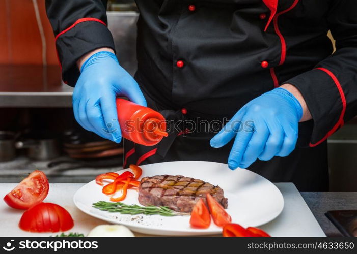 Chef set grilled meat. Chef set grilled meat steak on the plate