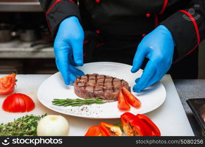 Chef set grilled meat. Chef set grilled meat steak on the plate