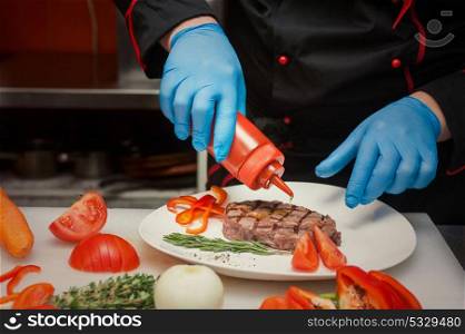 Chef set grilled meat. Chef set grilled meat steak on the plate