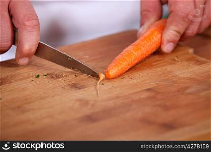 Chef slicing a carrot