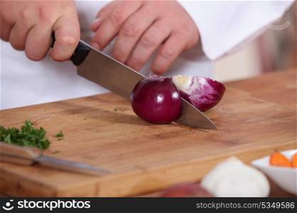 Chef slicing onion