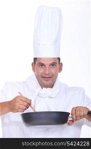 Chef stirring pan