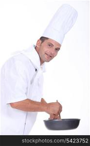Chef stirring sauce
