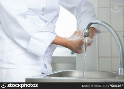 chef washing hand under running water