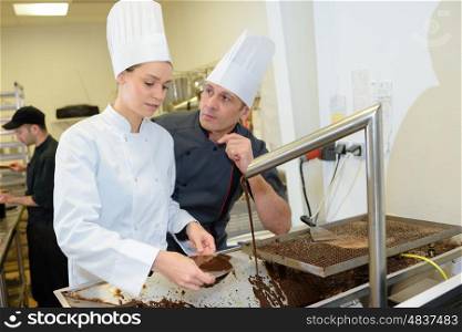chef with beautiful young assistant in restaurant kitchen