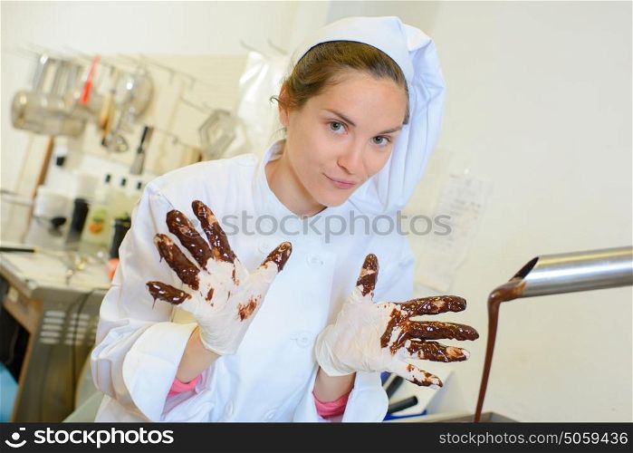 chef with chocolate on fingers