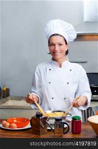Chef woman portrait with white uniform in the kitchen