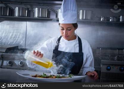 Chef woman working in kitchen with smoke and oil