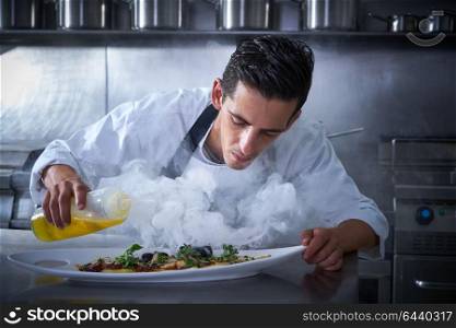 Chef working in kitchen with smoke and oil at restaurant