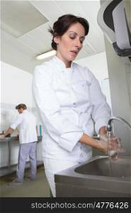 chefs hands washing her hands at commercial kitchen sink
