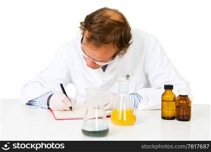 Chemical analyst taking notes after concluding his experiments in a laboratory