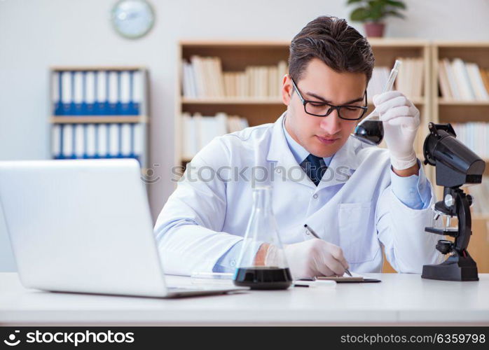 Chemical engineer working on oil samples in lab