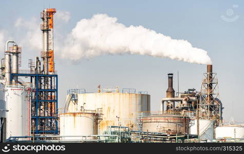 Chemical Factory plant with gas storage and structure of pipeline with smoke from smokestack in Kawasaki City near Tokyo Japan