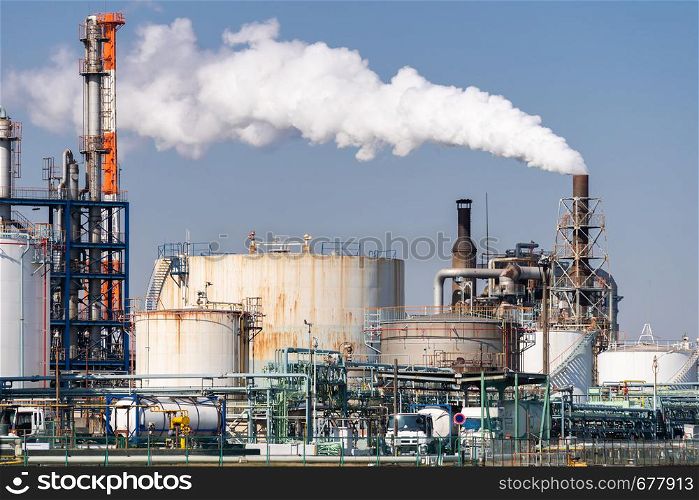 Chemical Factory plant with gas storage and structure of pipeline with smoke from smokestack in Kawasaki City near Tokyo Japan